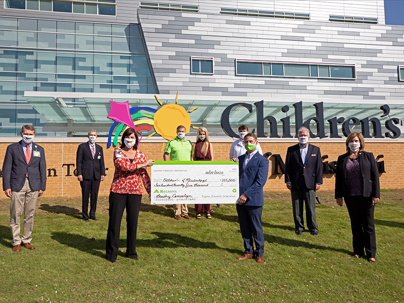 Celebrating Regions Bank’s presentation of a $225,000 donation to the Campaign for Children’s of Mississippi for the Kathy and Joe Sanderson Tower are, from left, Guy Giesecke, Children’s of Mississippi CEO; Robert McElhaney, UMMC associate comptroller for developmental accounting; Dr. Mary Taylor, Suzan B. Thames Chair and professor and chair of pediatrics at UMMC; Owen King, Regions Bank Brookhaven Branch manager; King’s daughter, Madeline, a Children’s of Mississippi patient; Dr. David Gilliam, a member of Madeline’s medical team; Robert Leard, Regions Bank Metro Jackson market executive; Alon Bee, Regions Bank Jackson Advisory Board chair and a member of the Campaign for Children’s of Mississippi Steering Committee; and Dr. LouAnn Woodward, UMMC vice chancellor for health affairs.